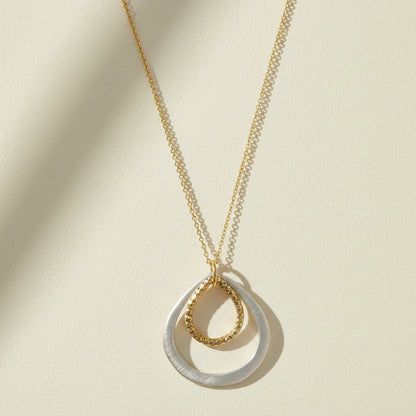 Two-tone double drop necklace with layered teardrop pendant and gold chain