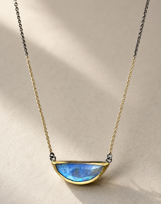 Gold-tone chain necklace with crescent blue gemstone pendant