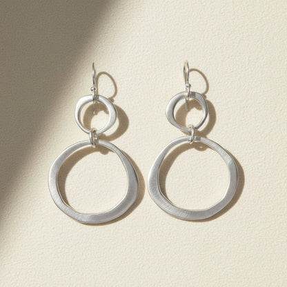 Silver circle drop earrings with small top hoop and large ring drops, lever-back