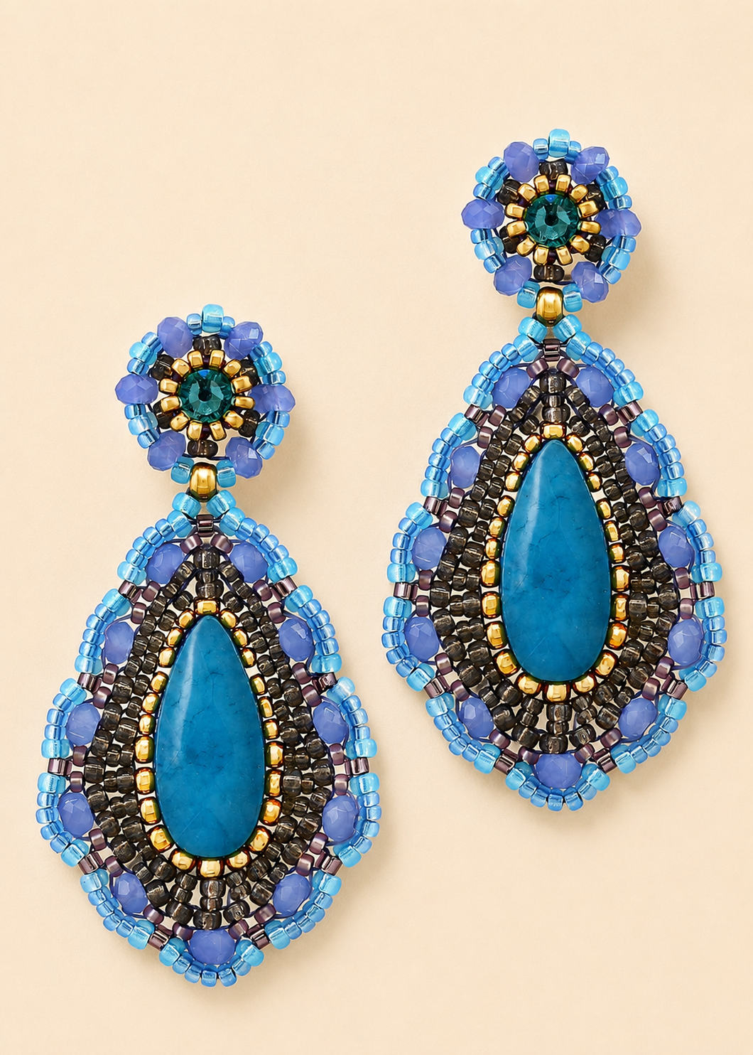 Blue beaded teardrop earrings with teal stone, gold trim, and hoop bead tops