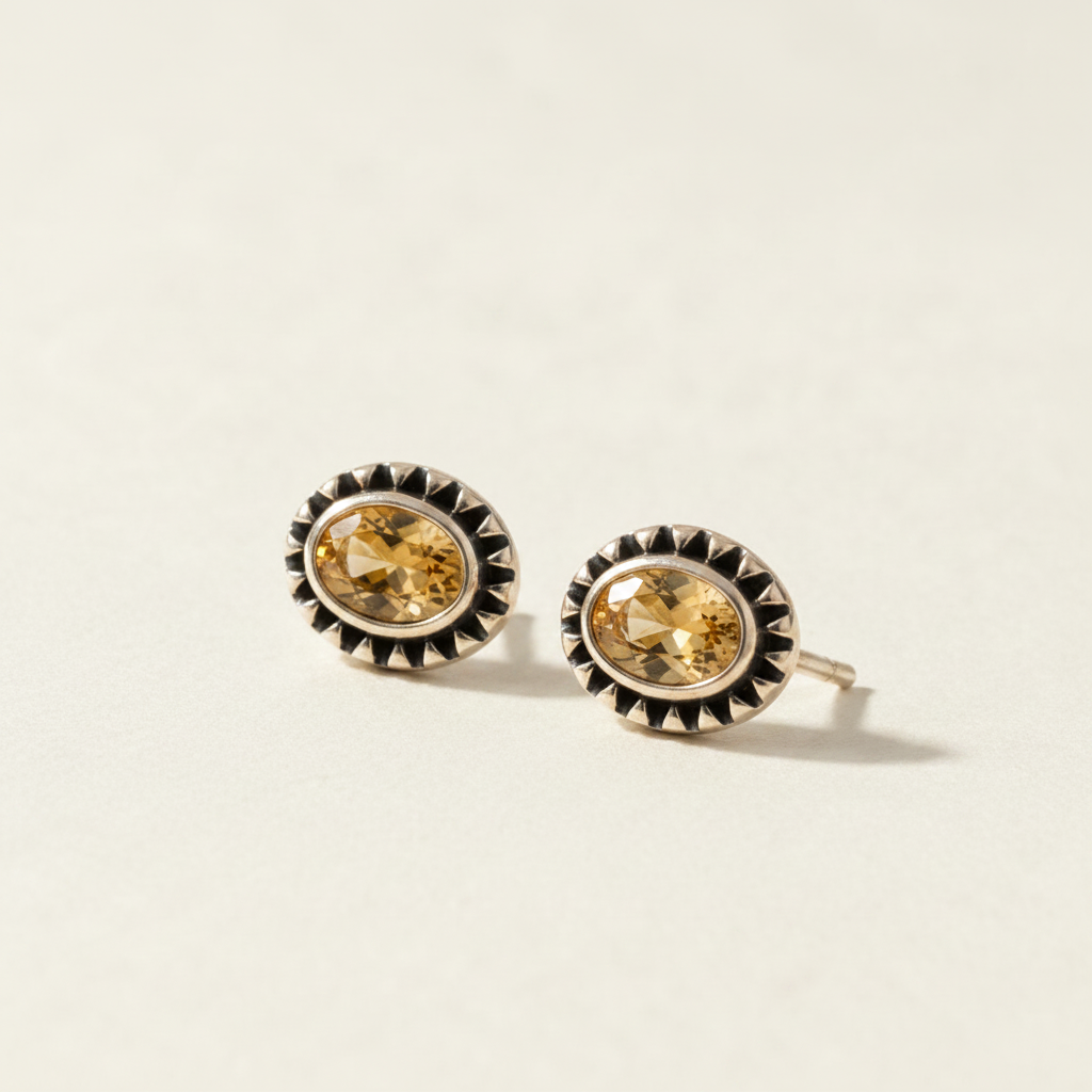 Gemstone stud earrings with golden yellow oval center and silver beaded halo
