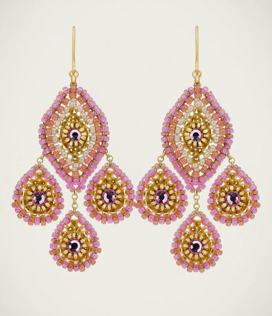 Pair of gold and pink beaded earrings on a light beige background