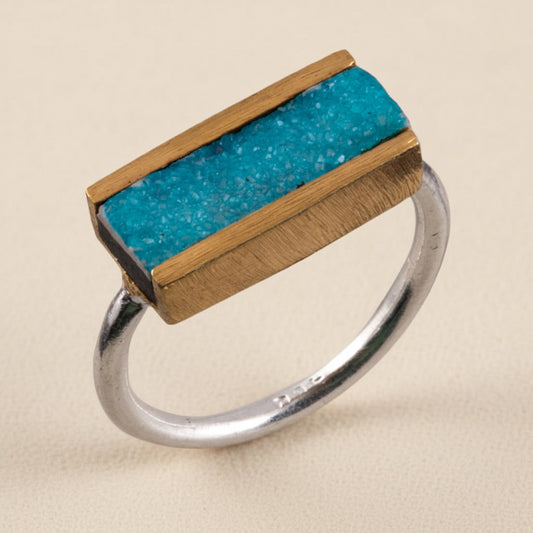Two-tone druzy bar ring with turquoise stone set on bronze bar atop a silver band