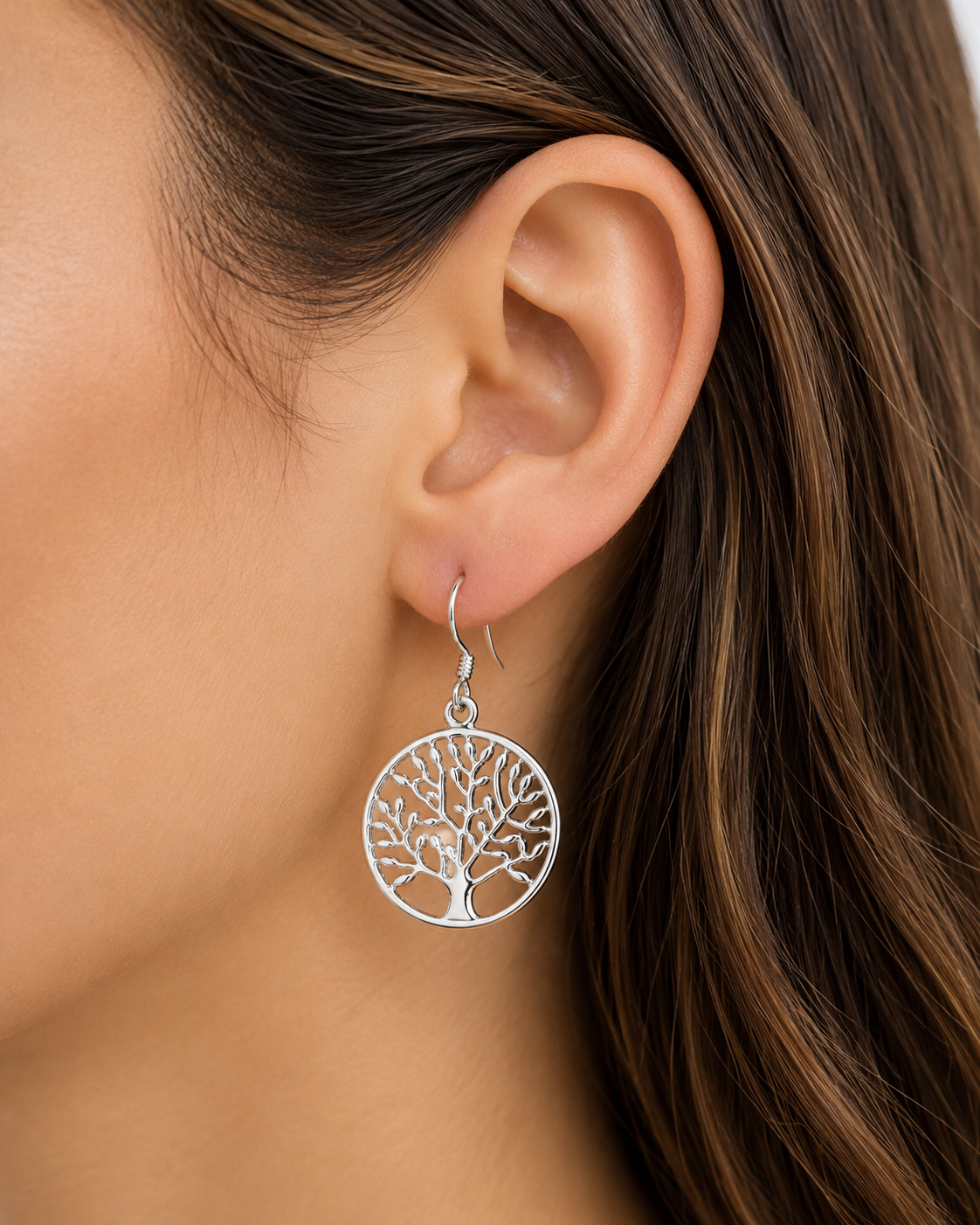 Silver-tone tree-of-life drop earring on hooked ear, round etched tree disc