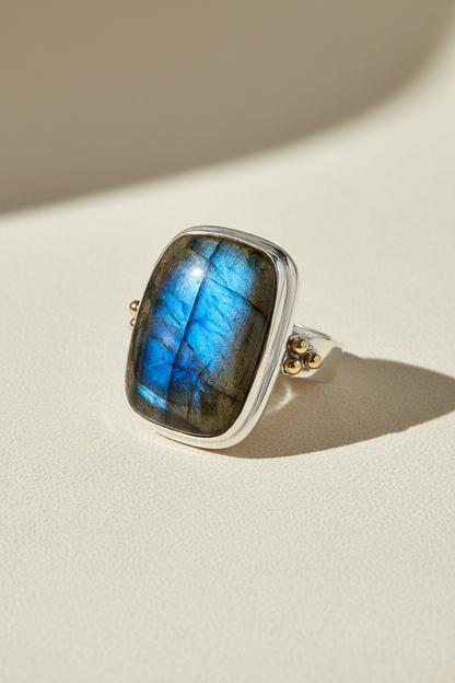 Blue labradorite square ring with silver border and visible brass accent on band