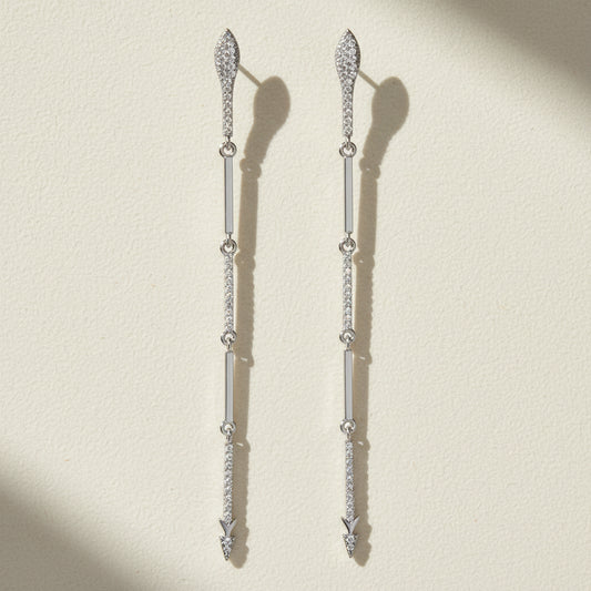 Silver-tone CZ dangle earrings with long drop design and small hanging stone accents