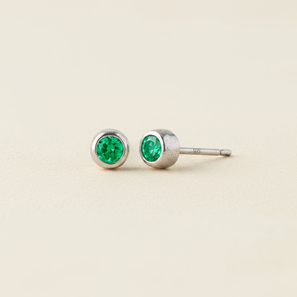 Tiny birthstone stud earrings with round green emerald CZ in silver-tone settings