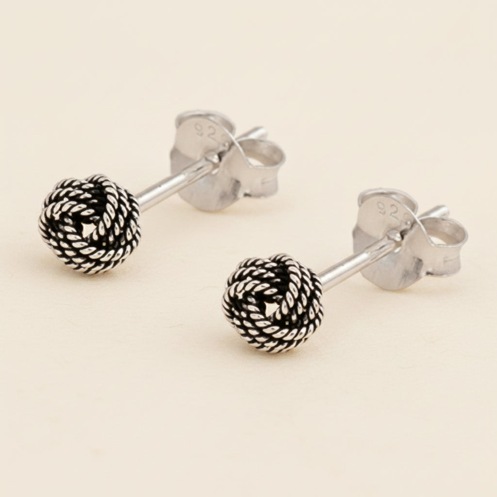Small rope-knot stud earrings with textured silver-tone round balls