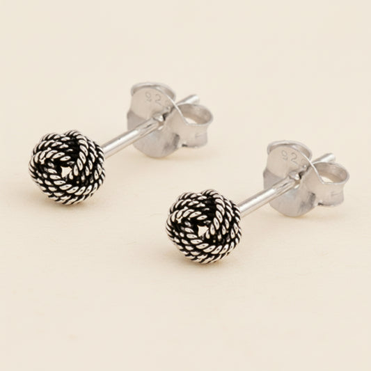 Small rope-knot stud earrings with textured silver-tone round balls