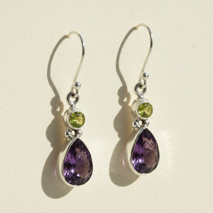 Silver-tone dangle earrings with green round and purple teardrop gemstones