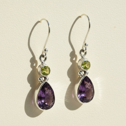Silver-tone dangle earrings with green round and purple teardrop gemstones