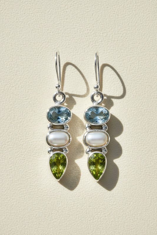 Silver-tone dangle earrings with blue gem, pearl drop, and green teardrop accents