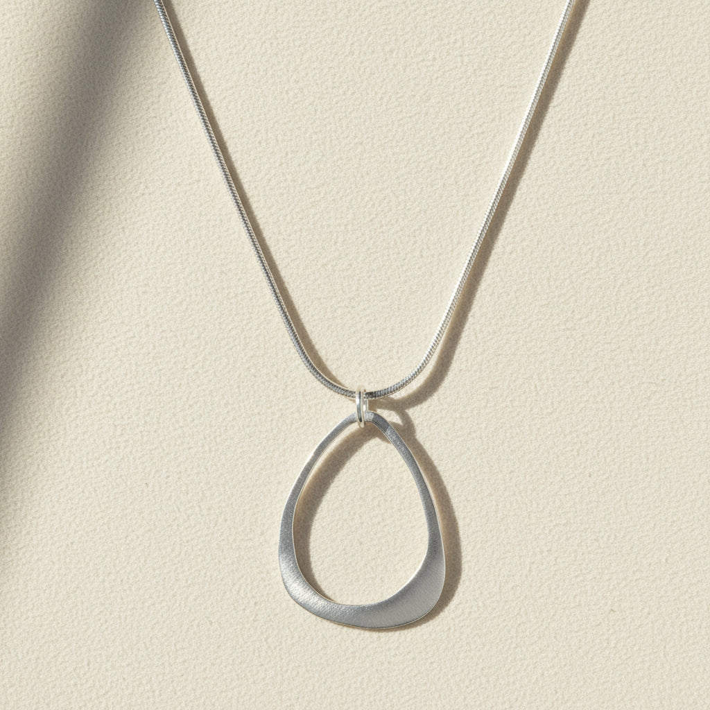 Open drop pendant necklace with open teardrop charm on silver chain