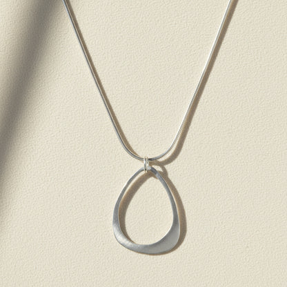 Open drop pendant necklace with open teardrop charm on silver chain