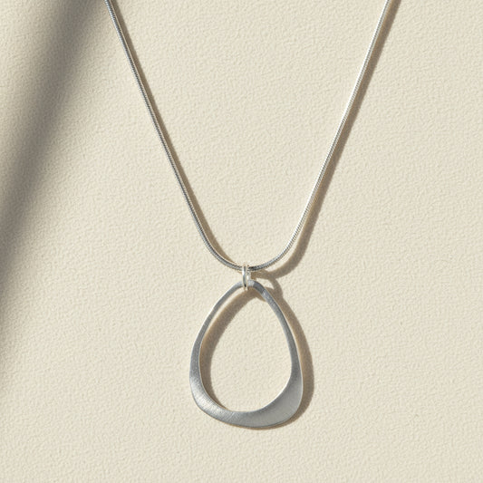 Open drop pendant necklace with open teardrop charm on silver chain