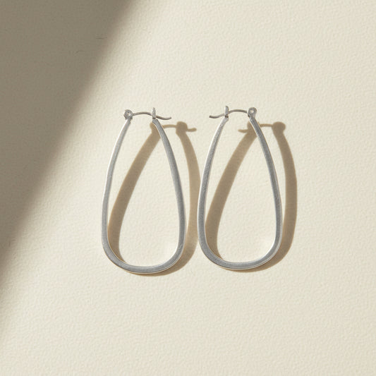 Large silver teardrop hoop earrings with hinge hook closure