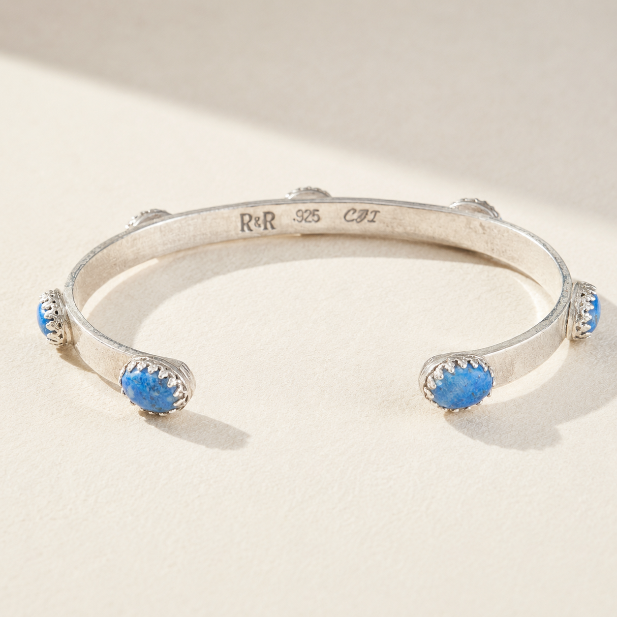 Silver cuff bracelet stamped 925 with two blue bead stones on open bangle