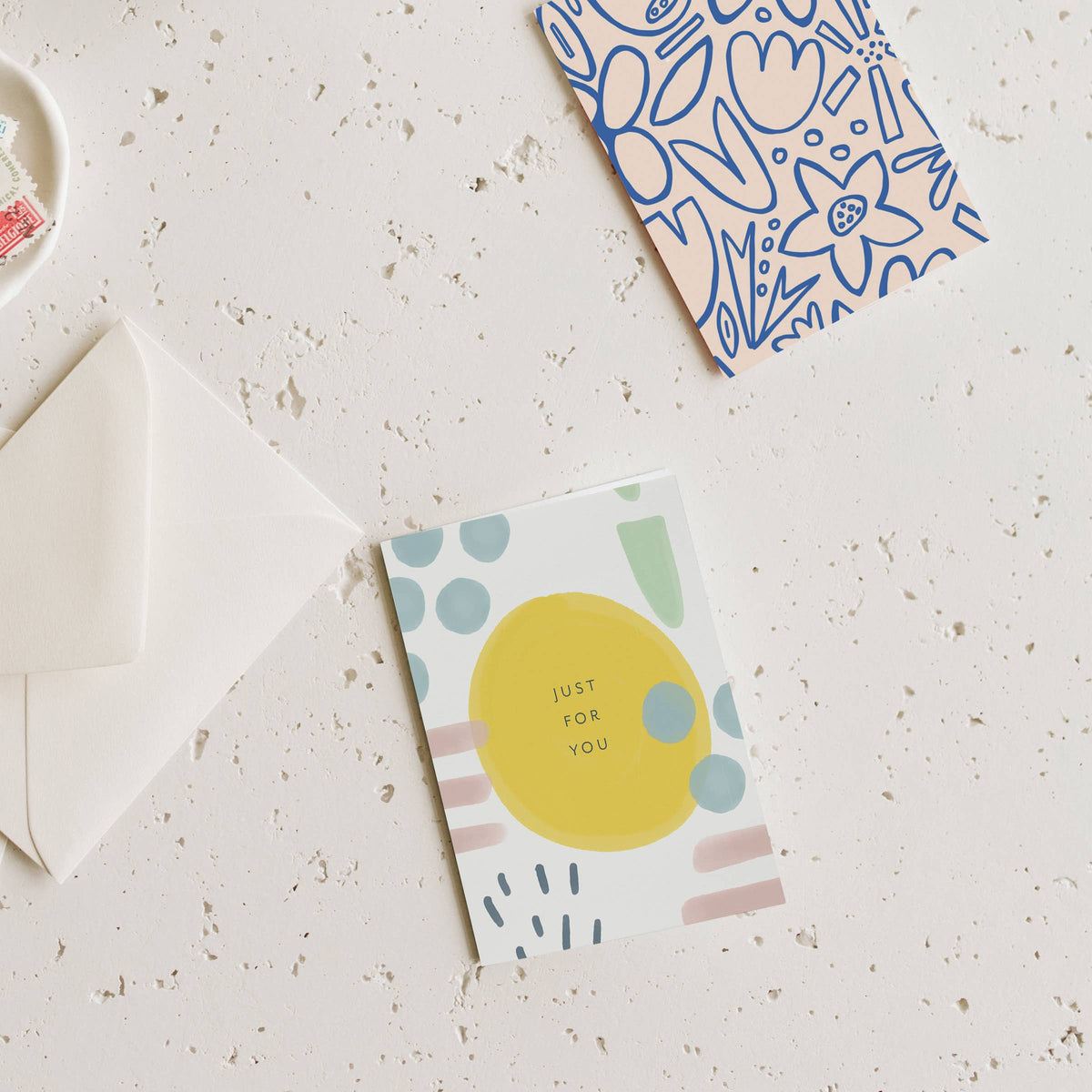 Garden-style mini greeting card with yellow circle and pastel dots, with white envelope.