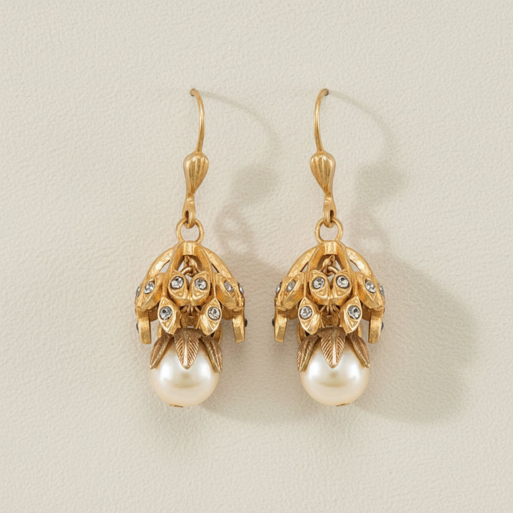 Gold-tone floral drop earrings with dangling faux pearl and textured charm caps