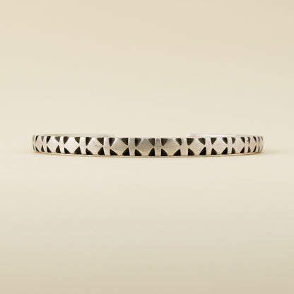 Diamond-pattern cuff bracelet with black-and-white stripe carvings