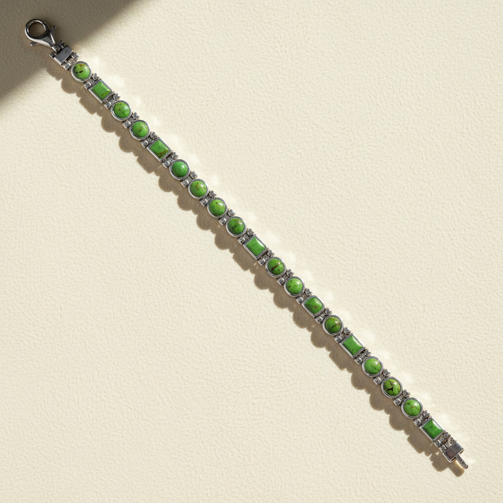 Beaded bracelet with green oval stones and silver spacer links, lobster clasp