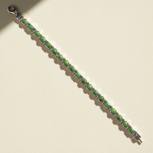 Beaded bracelet with green oval stones and silver spacer links, lobster clasp