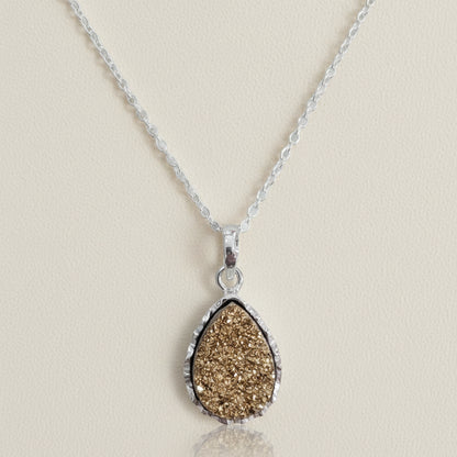 Teardrop druzy pendant necklace with silver-toned chain and gold druzy teardrop pendant