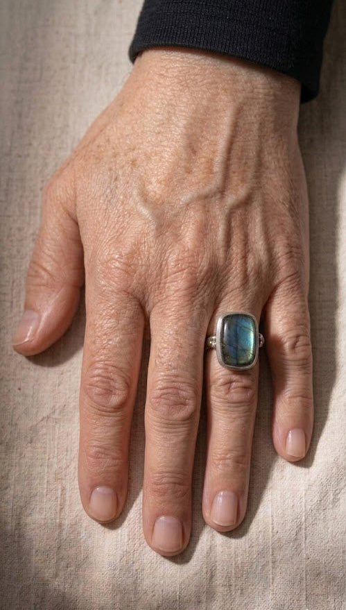 Labradorite ring worn on hand with square blue stone and silver shank