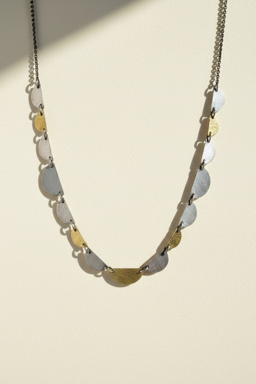 Hemi disc necklace with a long chain and stacked half-moon disc charms