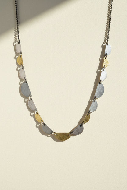 Hemi disc necklace with a long chain and stacked half-moon disc charms
