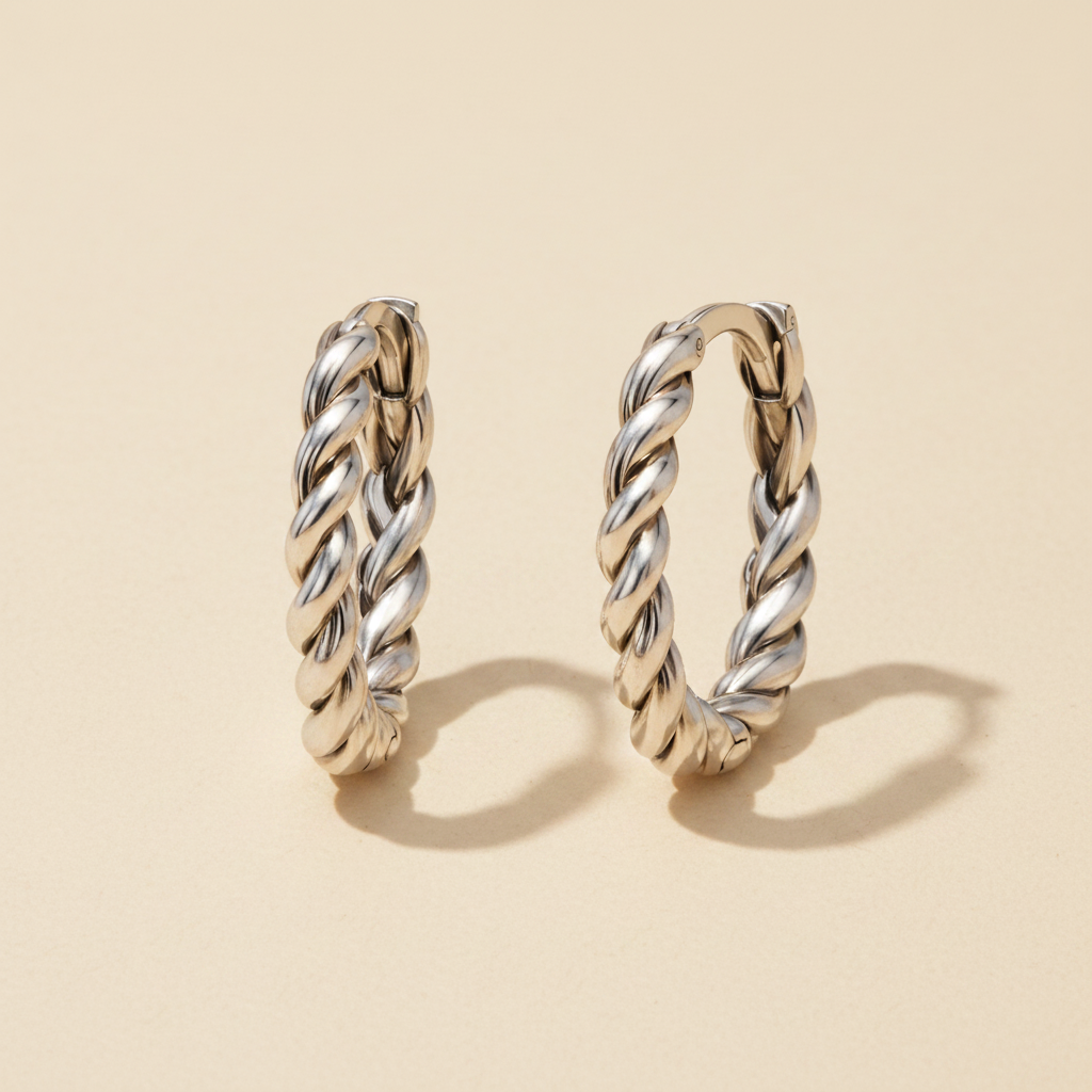 Braided huggie hoop earrings in polished silver tone, twisted rope design