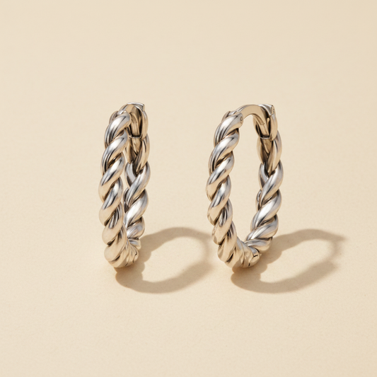 Braided huggie hoop earrings in polished silver tone, twisted rope design