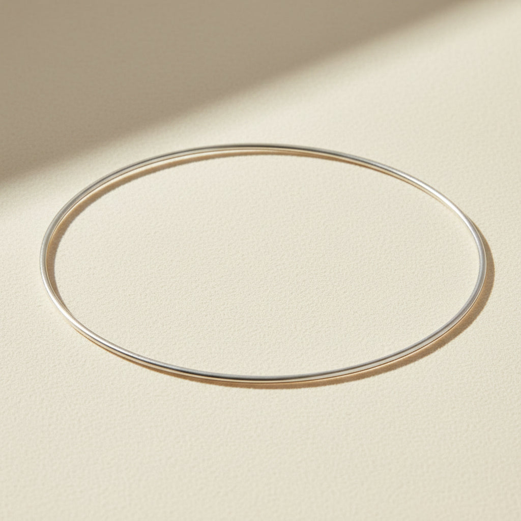 Thin silver bangle bracelet, smooth oval cuff