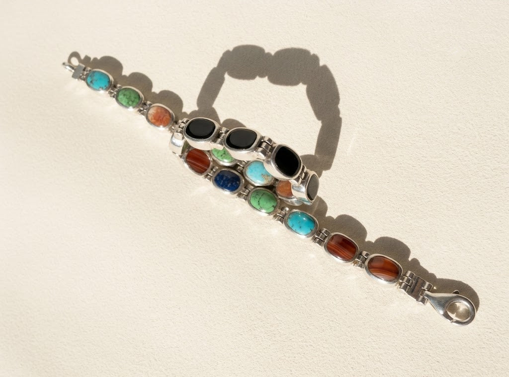 Silver reversible bracelet with turquoise and orange-brown oval cabochons and black stones