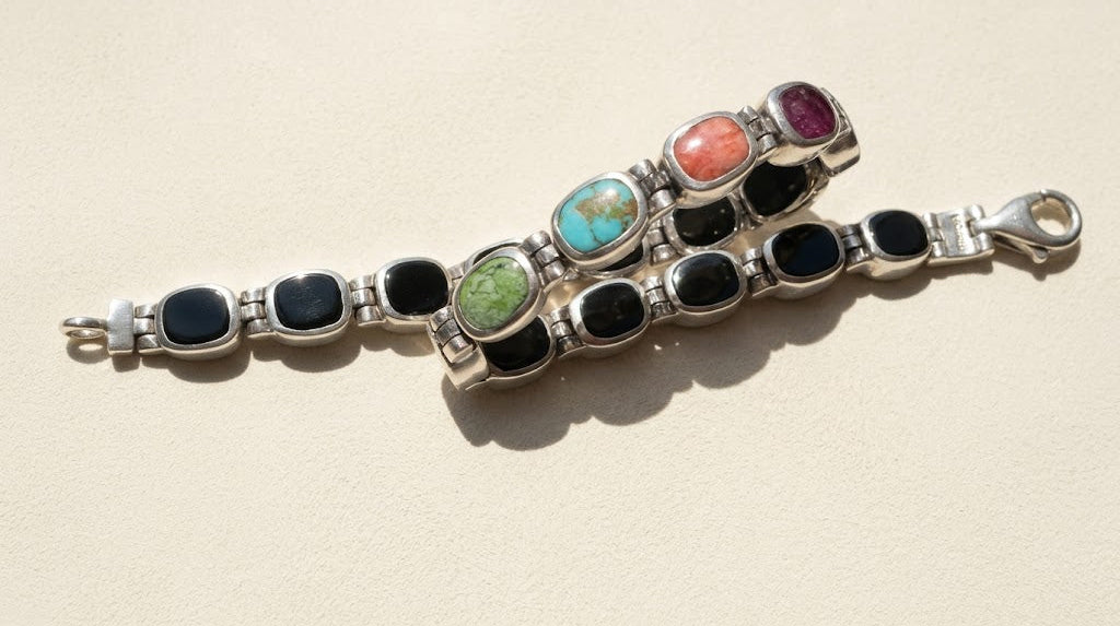 Silver bracelet with mixed oval cabochons: black onyx, green, turquoise, pink, and purple
