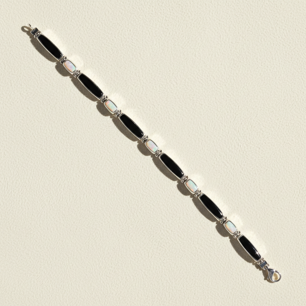 Black enamel link bracelet with light blue opal-style inlays and clasp, silver-tone