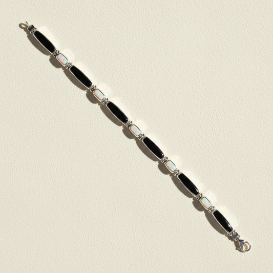 Black enamel link bracelet with light blue opal-style inlays and clasp, silver-tone