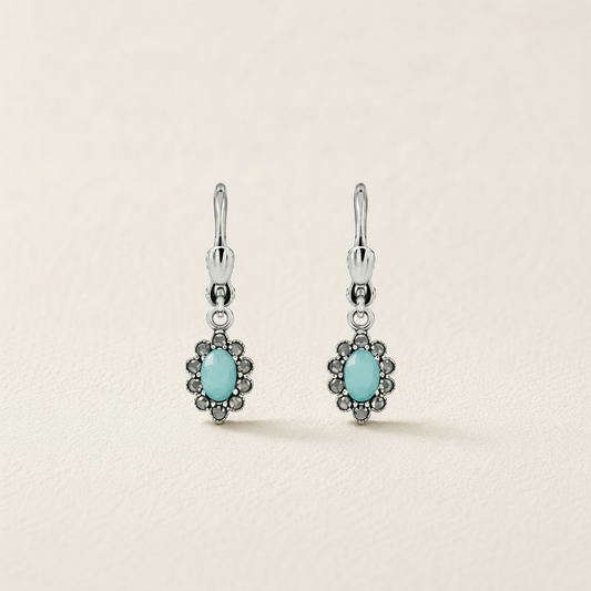 Silver-tone flower drop earrings with turquoise oval center and dark stone border