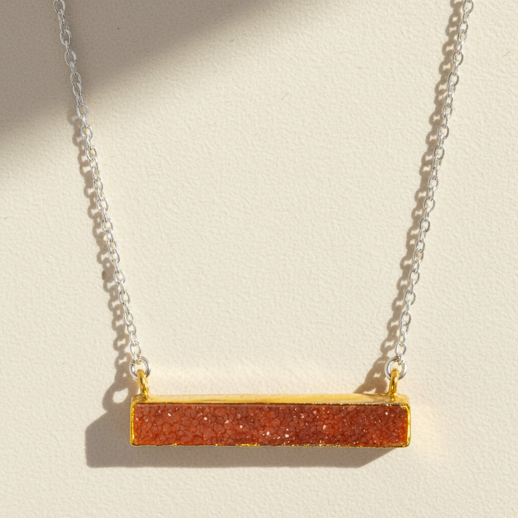 Two-tone druzy bar necklace with coral orange rectangular pendant on gold chain