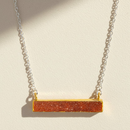 Two-tone druzy bar necklace with coral orange rectangular pendant on gold chain