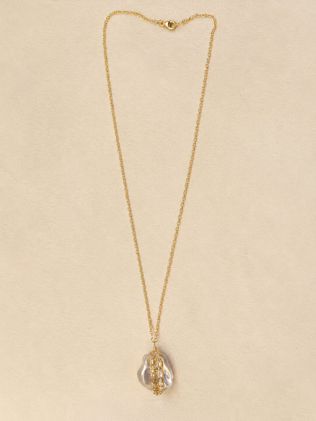 Gold chain necklace with small clasp and teardrop pearl bead-wrapped pendant