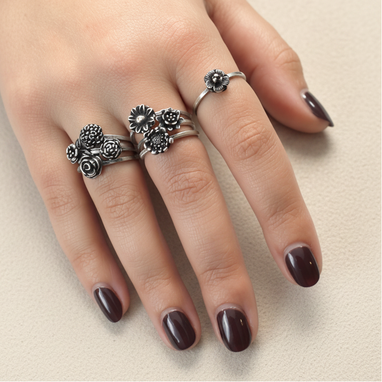 Sterling silver flower bouquet rings featuring clustered blossoms on fingers