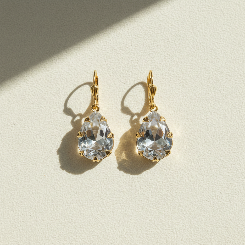 Gold-tone hoop earrings with clear faceted crystal drop