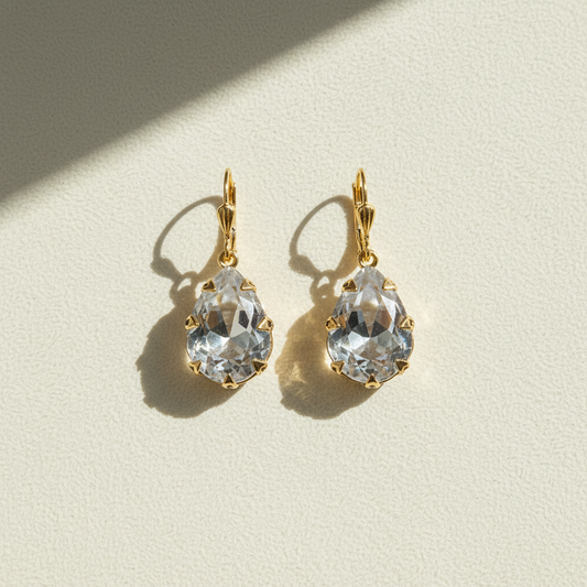 Gold-tone hoop earrings with clear faceted crystal drop
