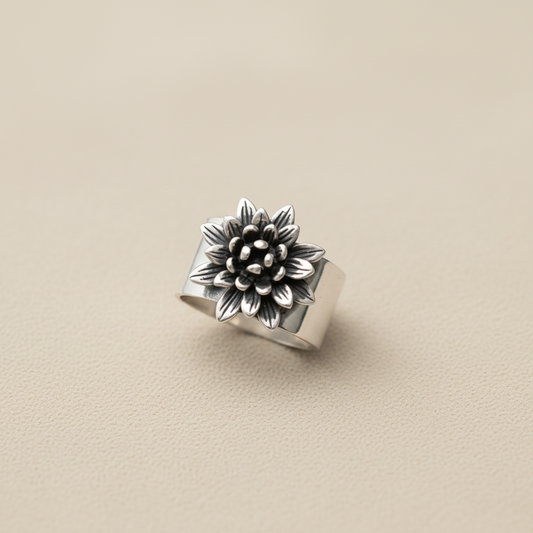 Silver ring with floral design on a white background