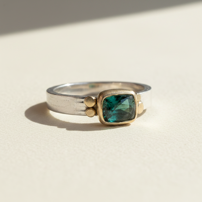 Silver ring with square dark-green gemstone and gold accents, tourmaline aura style