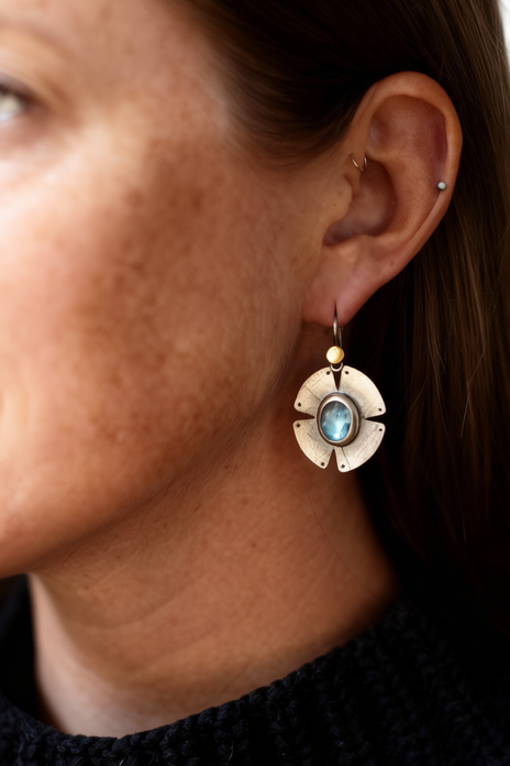 Gold-tone notch drop earrings with blue oval center and dangling round halo