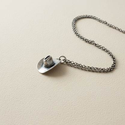 Silver-tone cowboy hat pendant necklace with circular hat charm on link chain