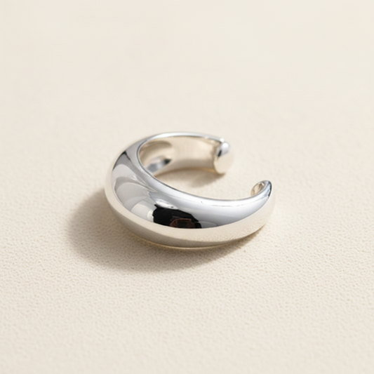 Wide ear cuff in polished silver tone, open C-shape with smooth edges