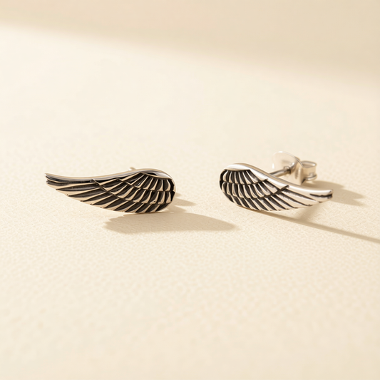 Silver-tone angel wing feather stud earrings with black striped feather detail